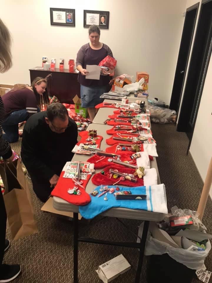 Volunteers setting up a stocking stuffing assembly line