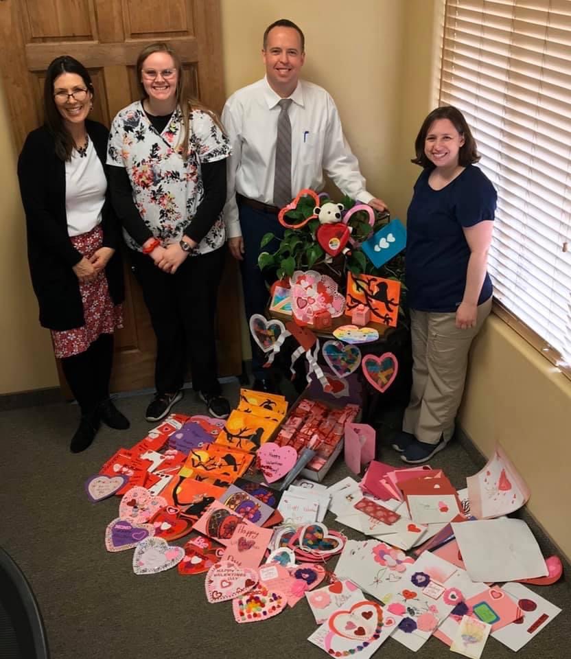 Donors taking pictures with the hand made valentines they made