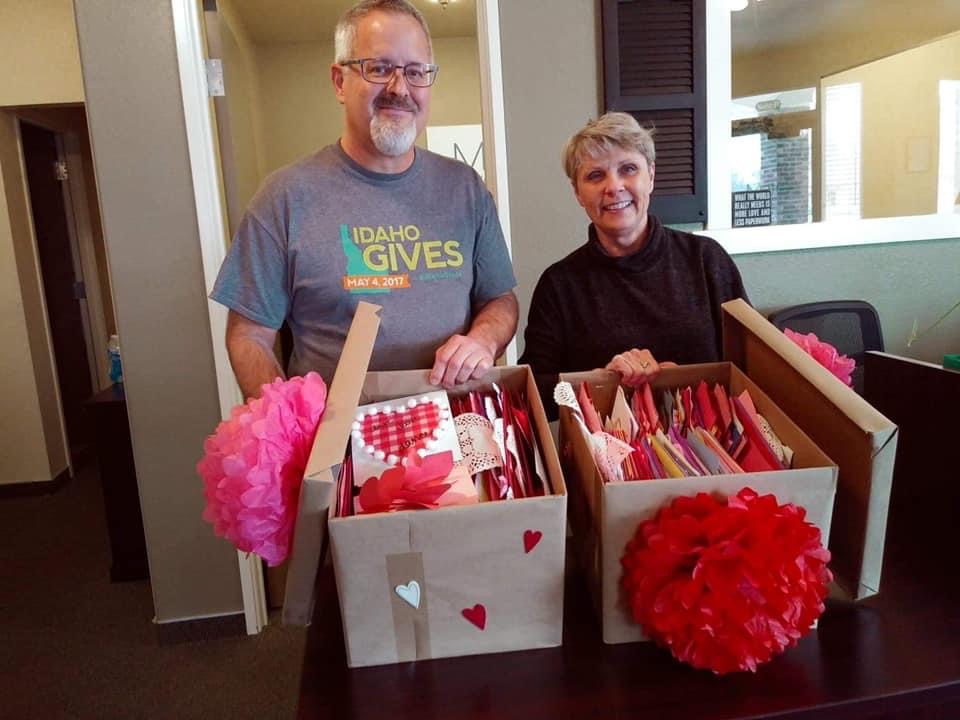 Two volunteers delivering boxes of handmade valentines
