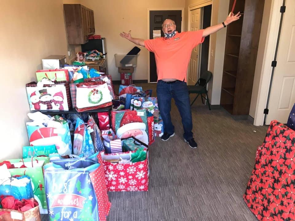 A male volunteer amazed at all of the gift bags being delivered