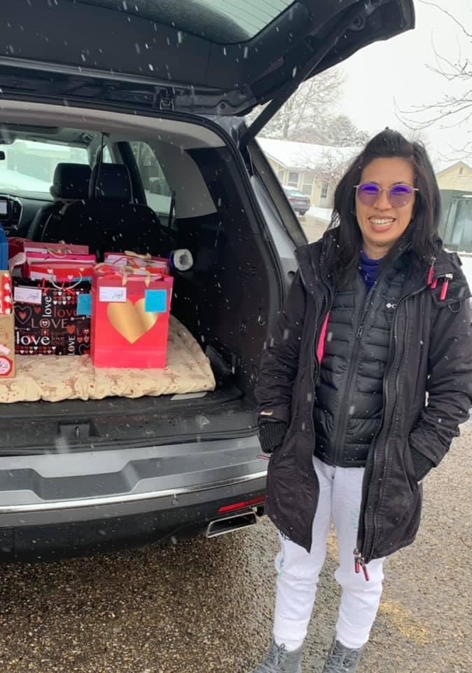 Volunteer dropping off donations with her car in the snow