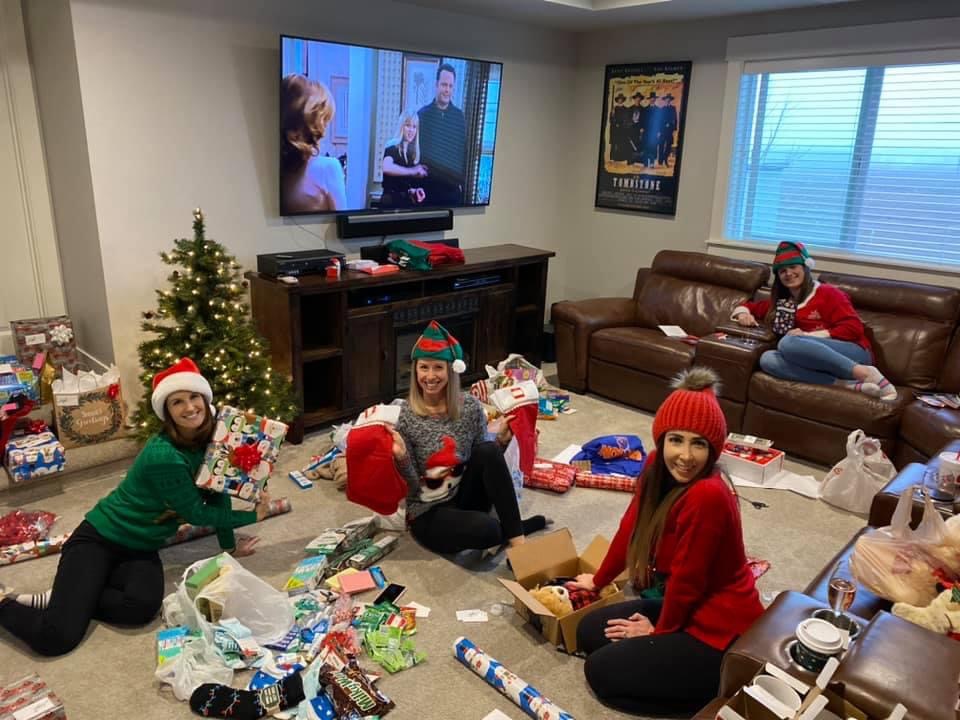 Volunteers having a gift wrapping gathering in their home for donations